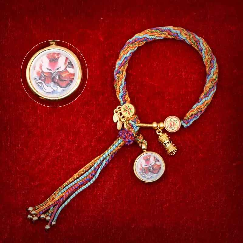 Bracelet en coton tissé, couleurs traditionnelles tibétaines et pendentif.