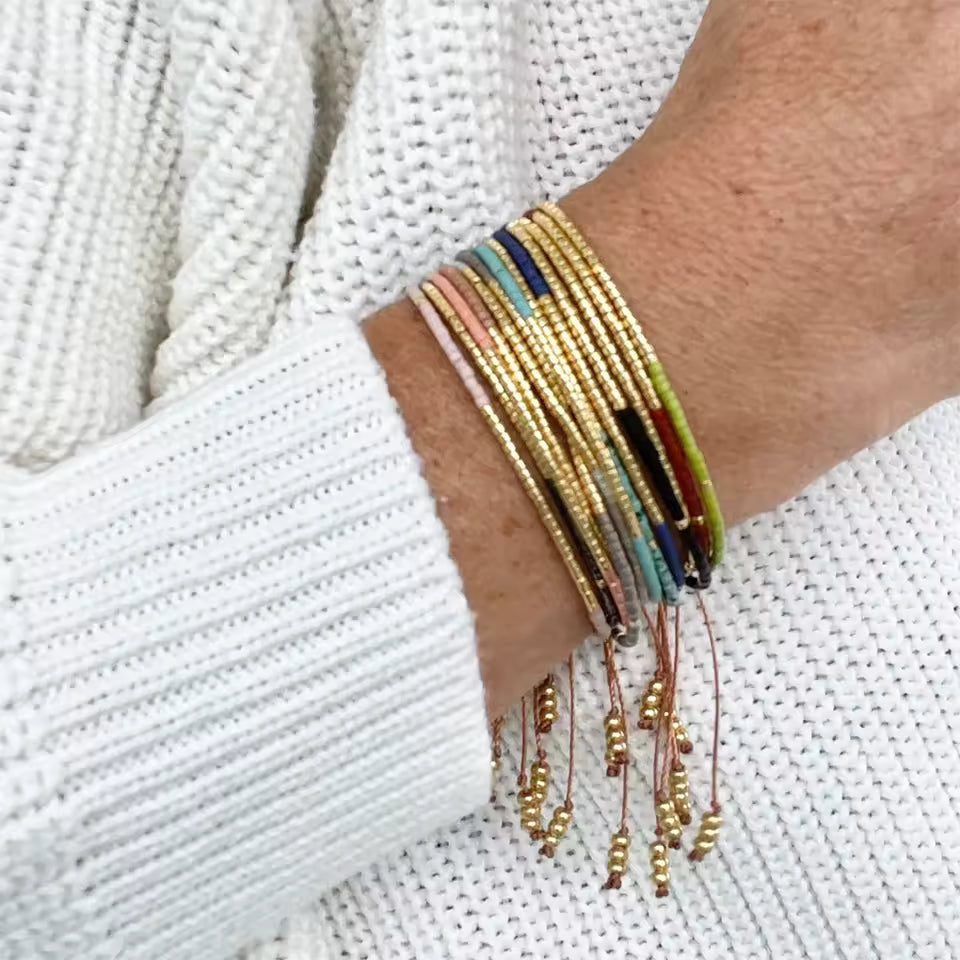 Bracelet fin en perles Miyuki roses et dorées au tissage régulier.