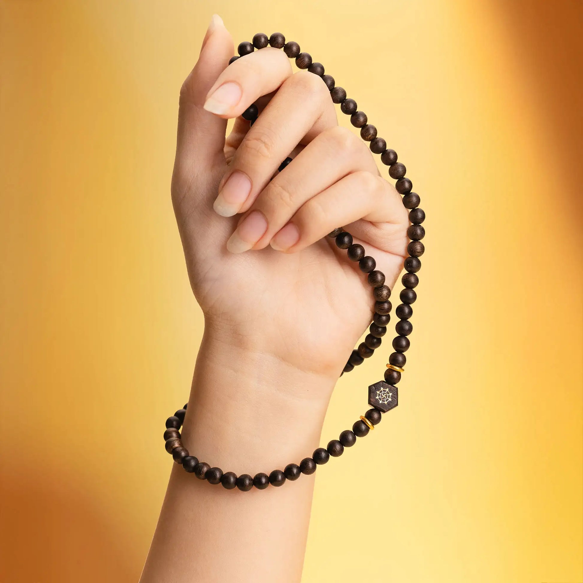 Détail du collier en bois d’agar mettant en valeur la structure des perles.