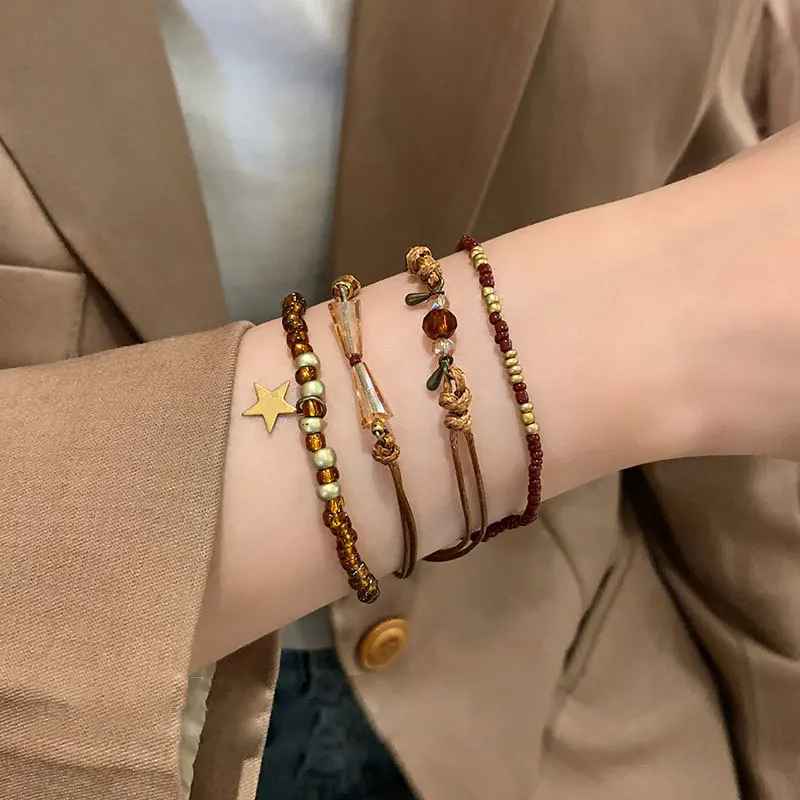 Ensemble de bracelets boho en perles de cristal marron dans un écrin beige.